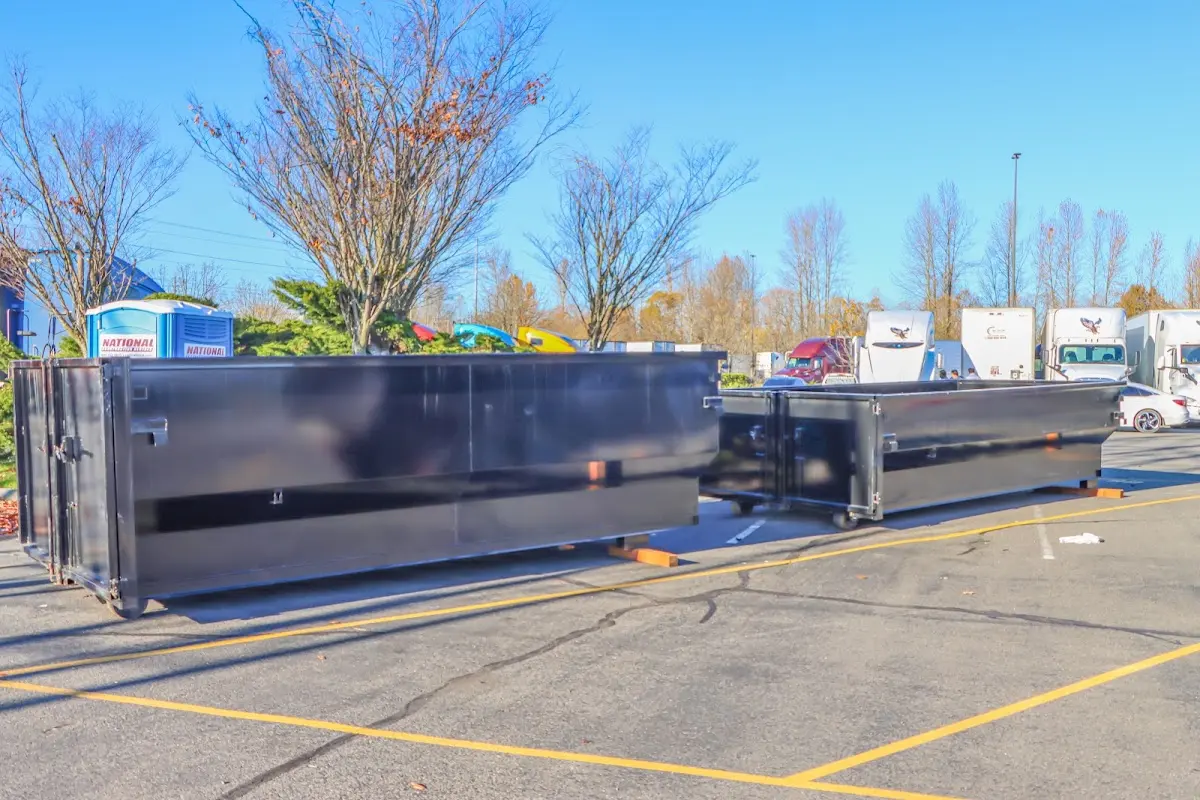 Professional dumpster rental service with roll-off container on residential driveway in Modesto